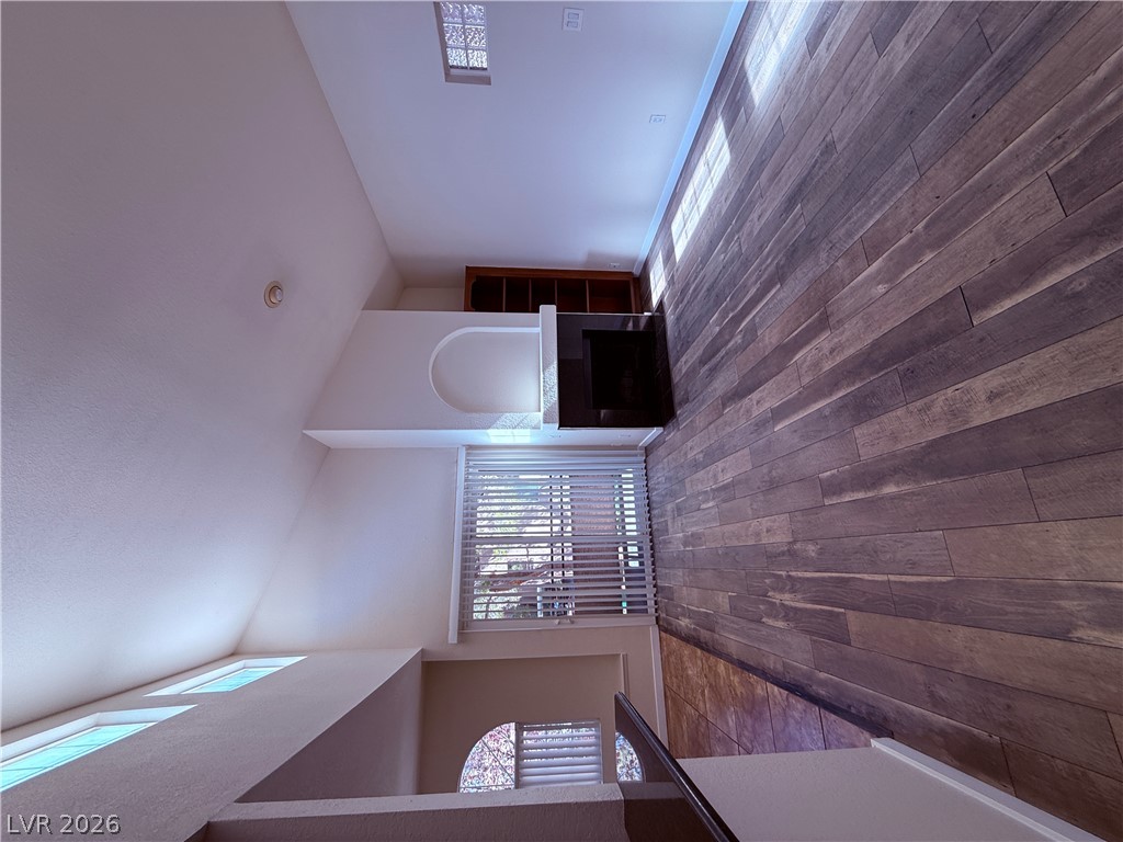 9325 West Desert Inn Road, Unit 260 Las Vegas, NV 89117 - Photo 2 of 42 Dramatic vaulted ceilings enhance this inviting living space with striking hardwood floors.