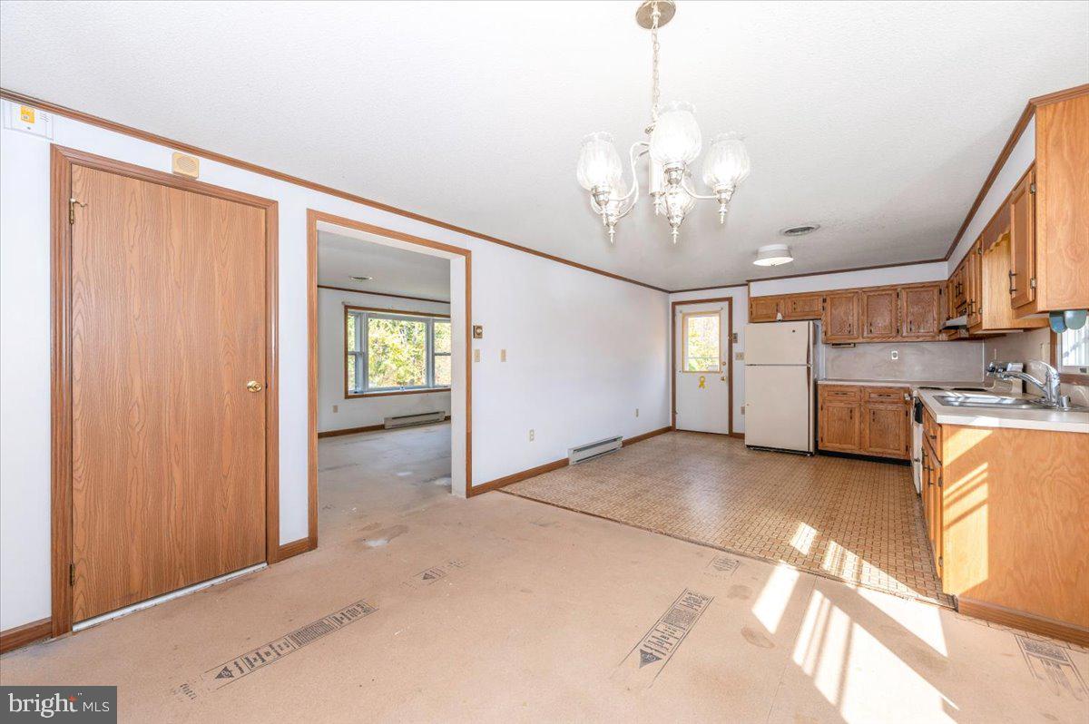 29007 Ridge Road Mount Airy, MD 21771 - Photo 17 of 50 a view of a kitchen with cabinet and a chandelier fan
