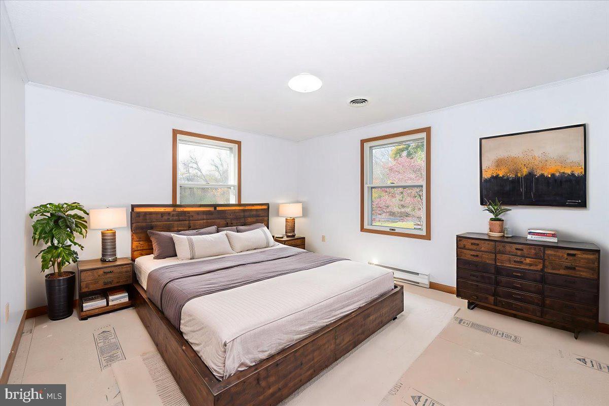 29007 Ridge Road Mount Airy, MD 21771 - Photo 23 of 50 a bedroom with a bed and a flat screen tv