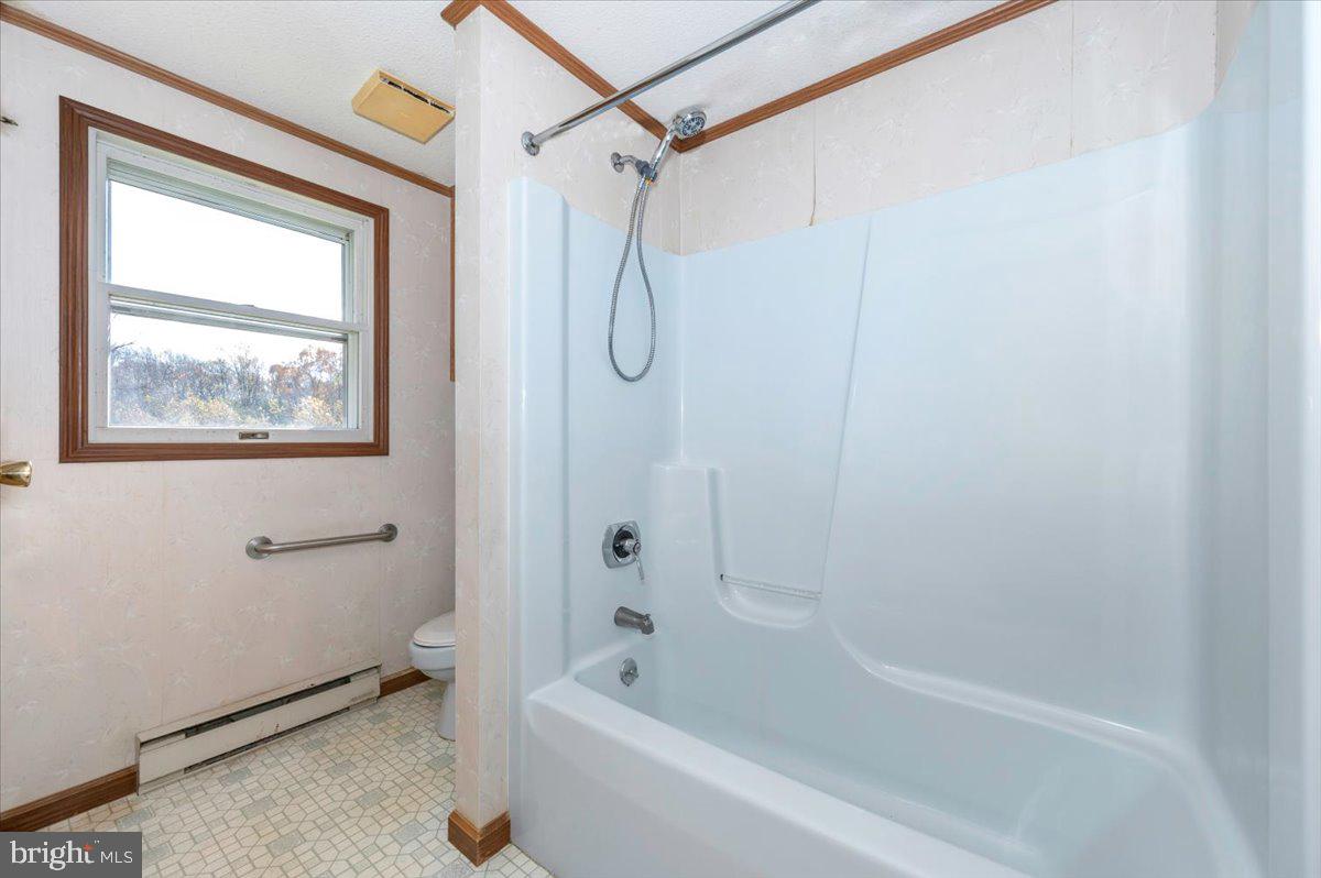 29007 Ridge Road Mount Airy, MD 21771 - Photo 32 of 50 a bathroom with a shower and a bath tub