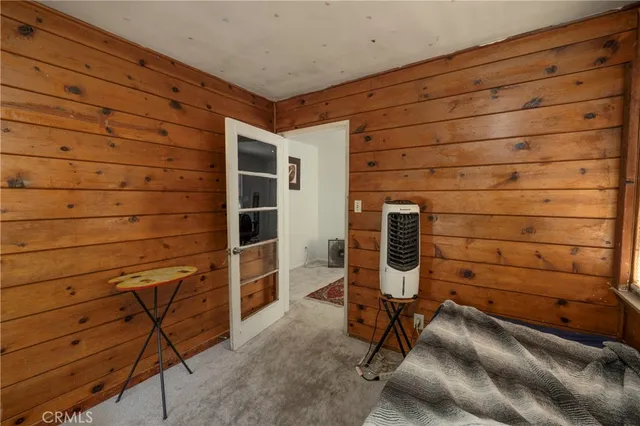 a bedroom with a bed and a chair