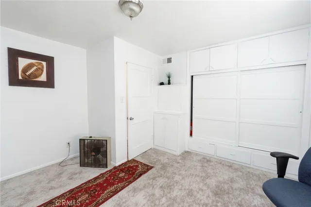 a view of a workspace with a window and a chair