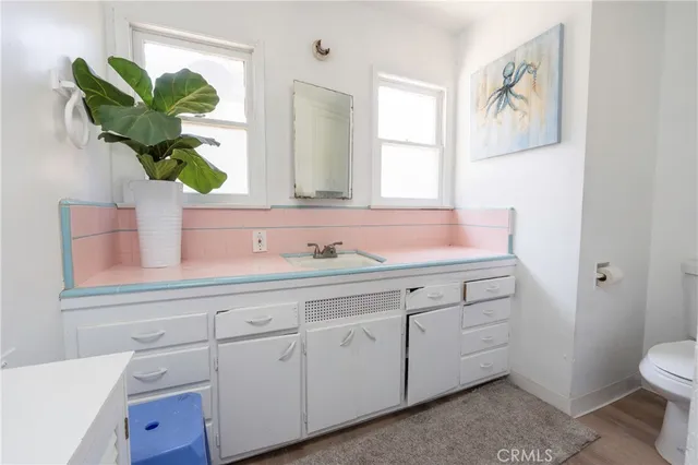 a white toilet sitting next to a shower