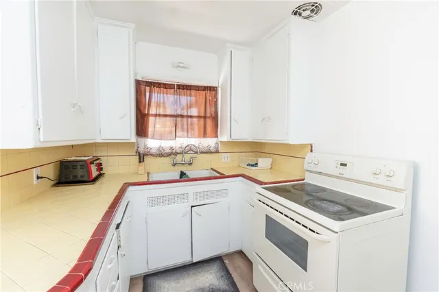 a kitchen that has a sink and a stove