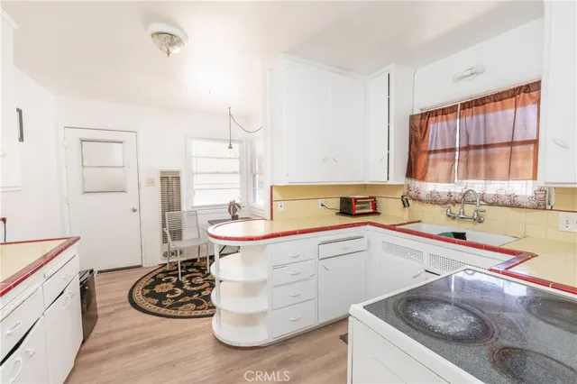 a kitchen with a sink stove and window