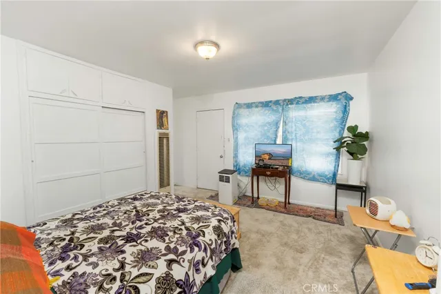 a bedroom with a bed and a table in it