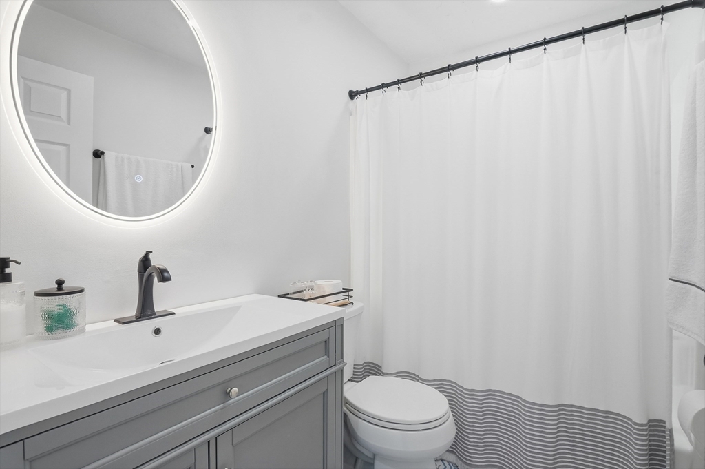 425 Main Street, Unit 21D Hudson, MA 01749 - Photo 13 of 21 a bathroom with a sink a toilet and a mirror