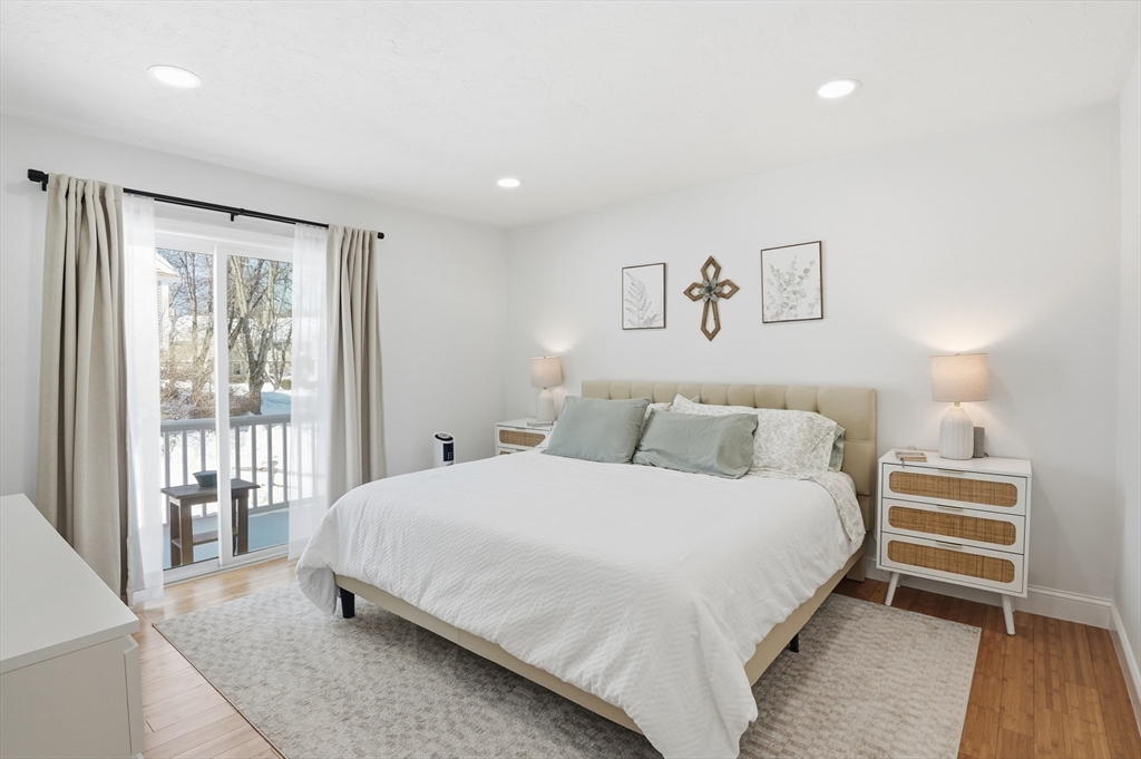 425 Main Street, Unit 21D Hudson, MA 01749 - Photo 14 of 21 a bedroom with a bed and a large window