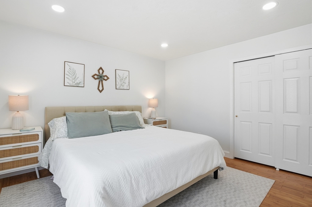 425 Main Street, Unit 21D Hudson, MA 01749 - Photo 16 of 21 a bedroom with a bed and a night stand