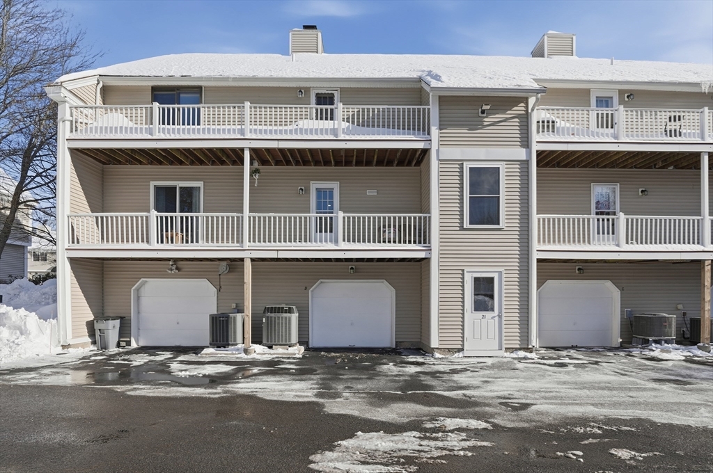 425 Main Street, Unit 21D Hudson, MA 01749 - Photo 18 of 21 a front view of a house with a yard and parking space