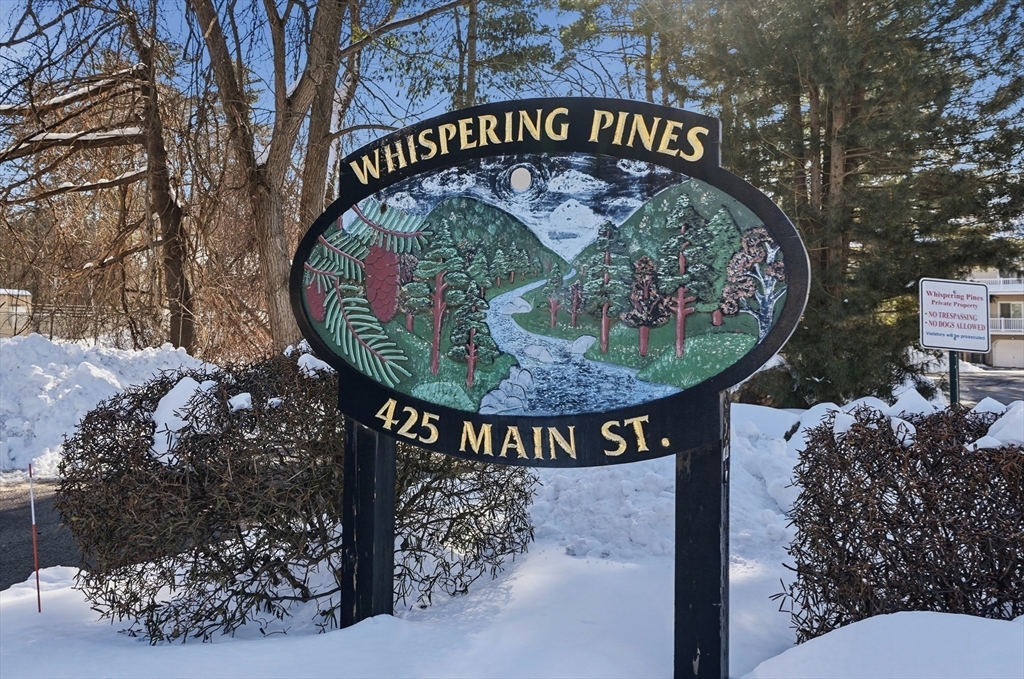 425 Main Street, Unit 21D Hudson, MA 01749 - Photo 21 of 21 a sign that is on a wooden wall