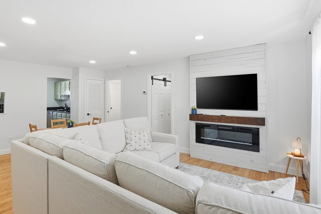 425 Main Street, Unit 21D Hudson, MA 01749 - Photo 3 of 21 a living room with furniture and a flat screen tv