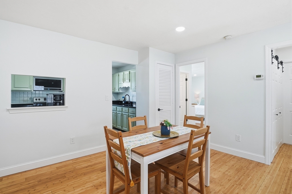 425 Main Street, Unit 21D Hudson, MA 01749 - Photo 4 of 21 a view of a dining room with furniture and wooden floor