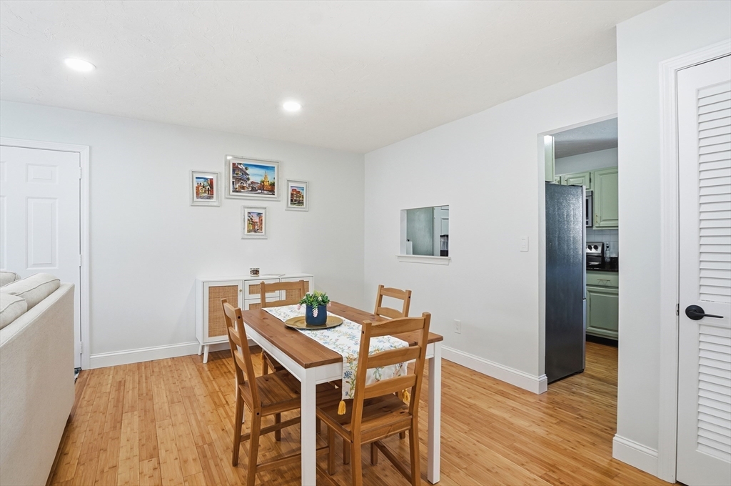 425 Main Street, Unit 21D Hudson, MA 01749 - Photo 5 of 21 a view of a dining room with furniture and wooden floor