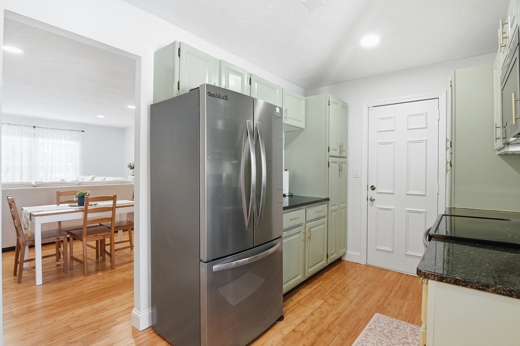 425 Main Street, Unit 21D Hudson, MA 01749 - Photo 7 of 21 a kitchen with stainless steel appliances granite countertop a refrigerator and a stove top oven