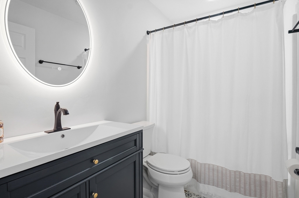 425 Main Street, Unit 21D Hudson, MA 01749 - Photo 10 of 21 a bathroom with a sink and a mirror