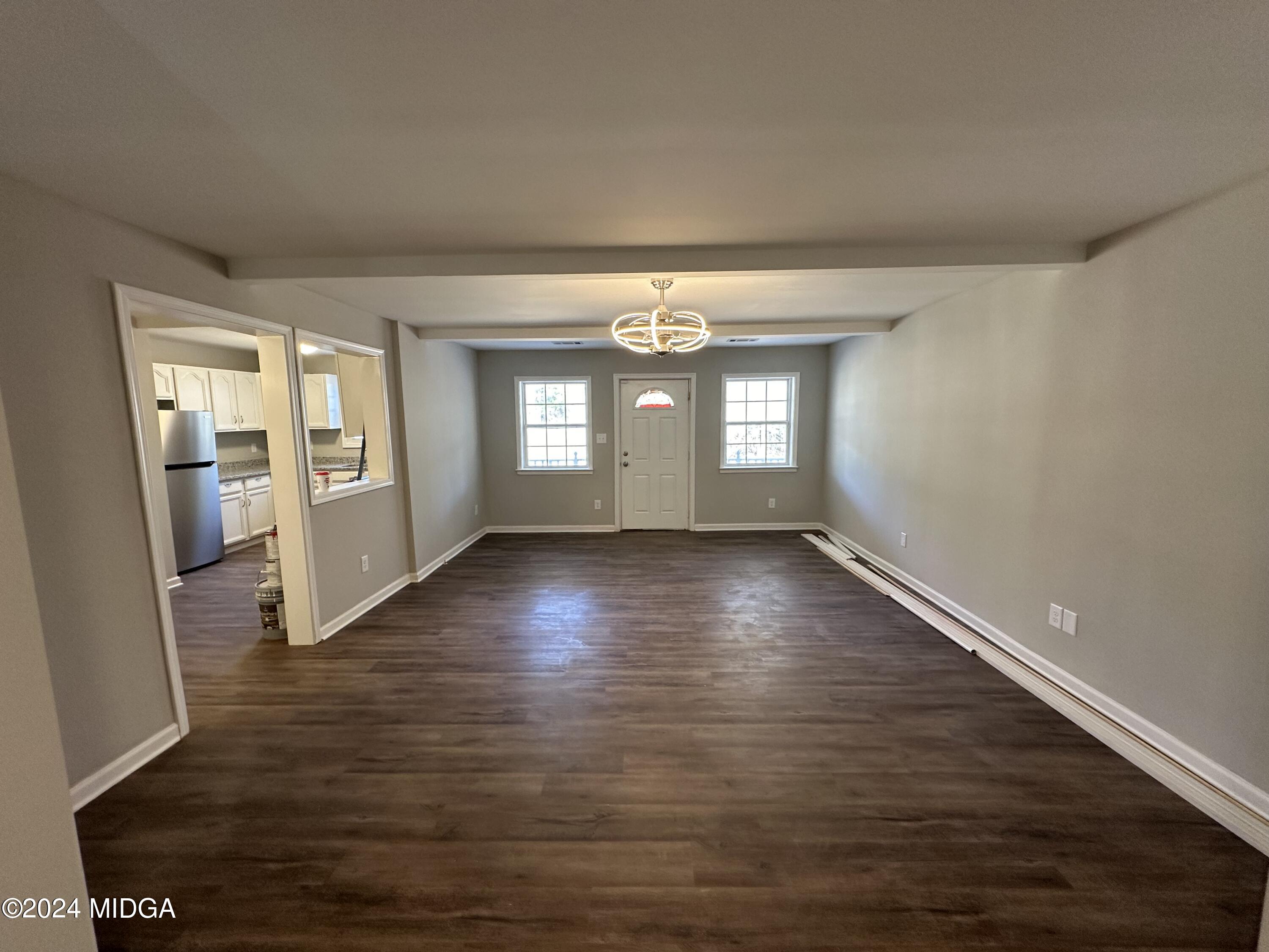 365 Taylor Road Juliette, GA 31046 - Photo 6 of 12 an empty room with wooden floor and windows