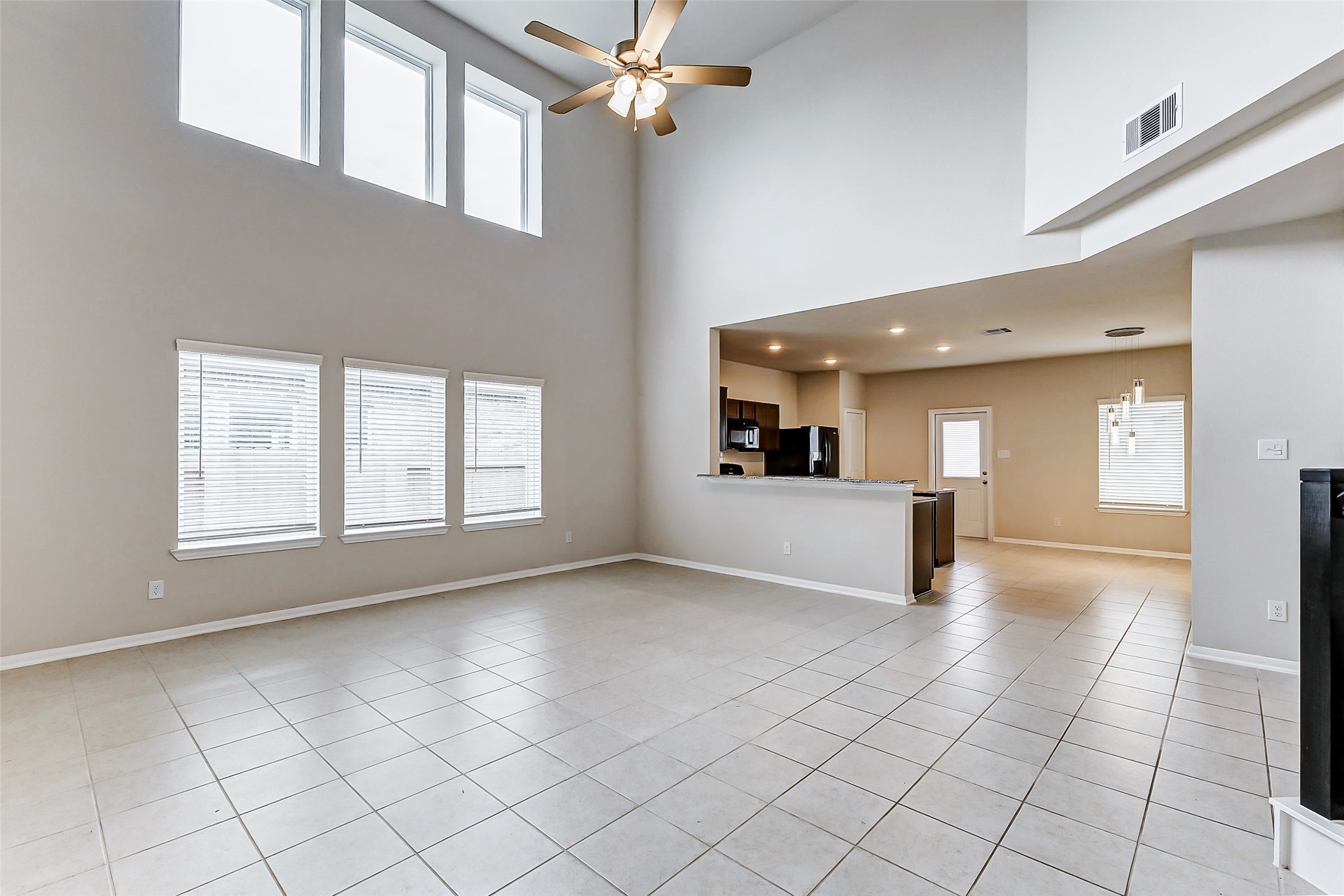 10511 Snowy Ridge Lane Rosharon, TX 77583 - Photo 3 of 32 a view of empty room with a fireplace and windows