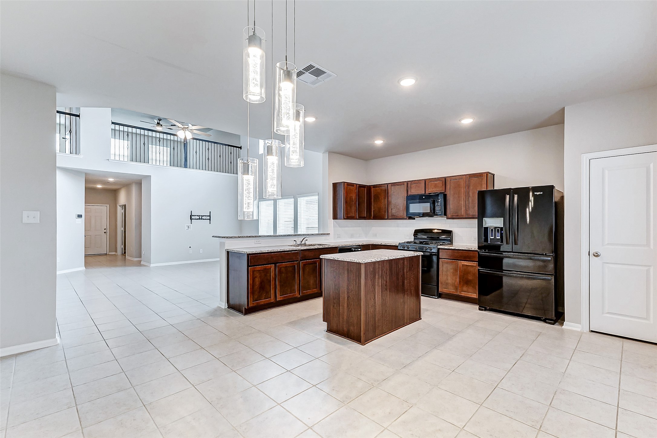 10511 Snowy Ridge Lane Rosharon, TX 77583 - Photo 6 of 32 a kitchen with stainless steel appliances kitchen island granite countertop a refrigerator and a stove top oven