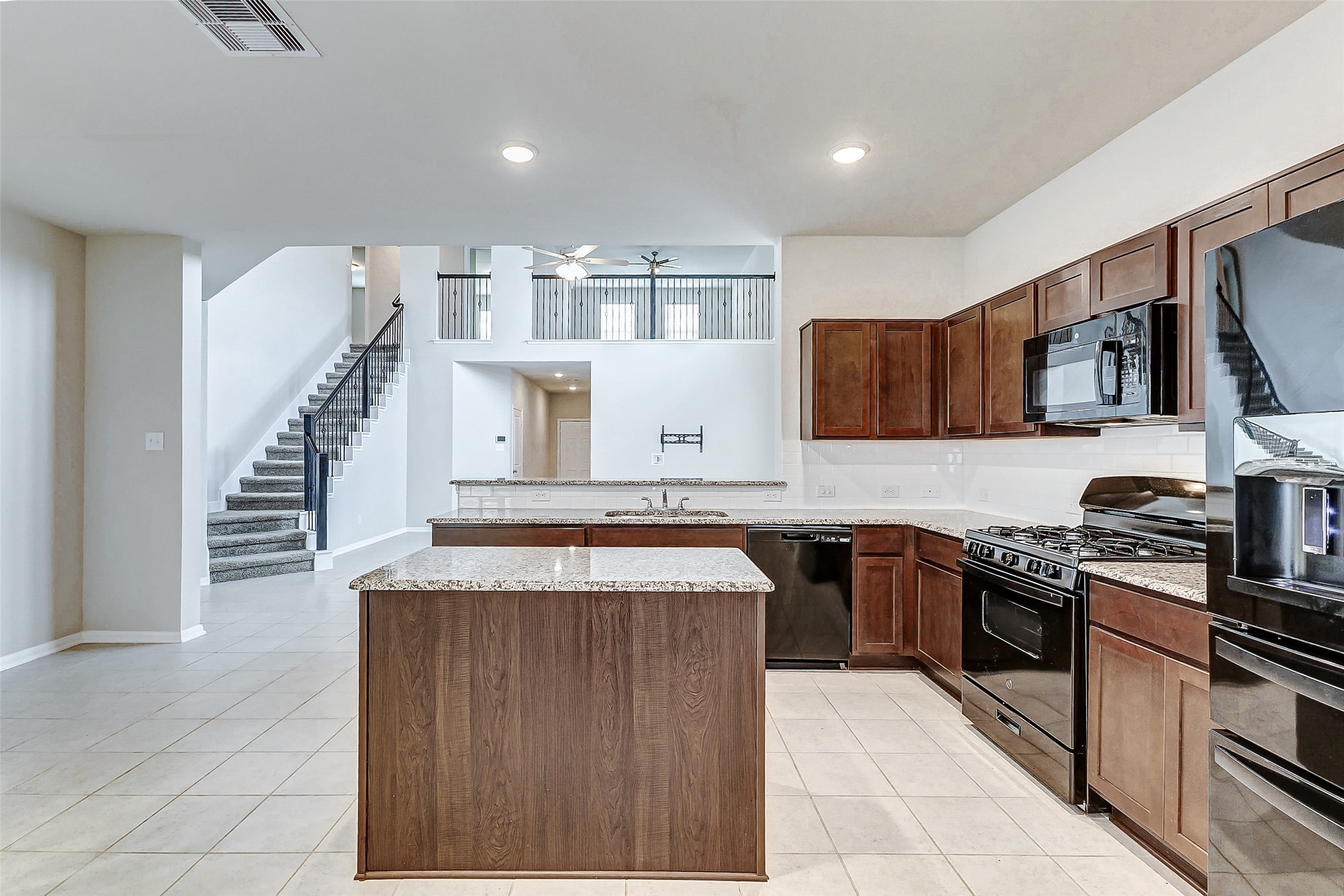 10511 Snowy Ridge Lane Rosharon, TX 77583 - Photo 7 of 32 a kitchen with stainless steel appliances granite countertop a stove top oven a sink a counter space and cabinets