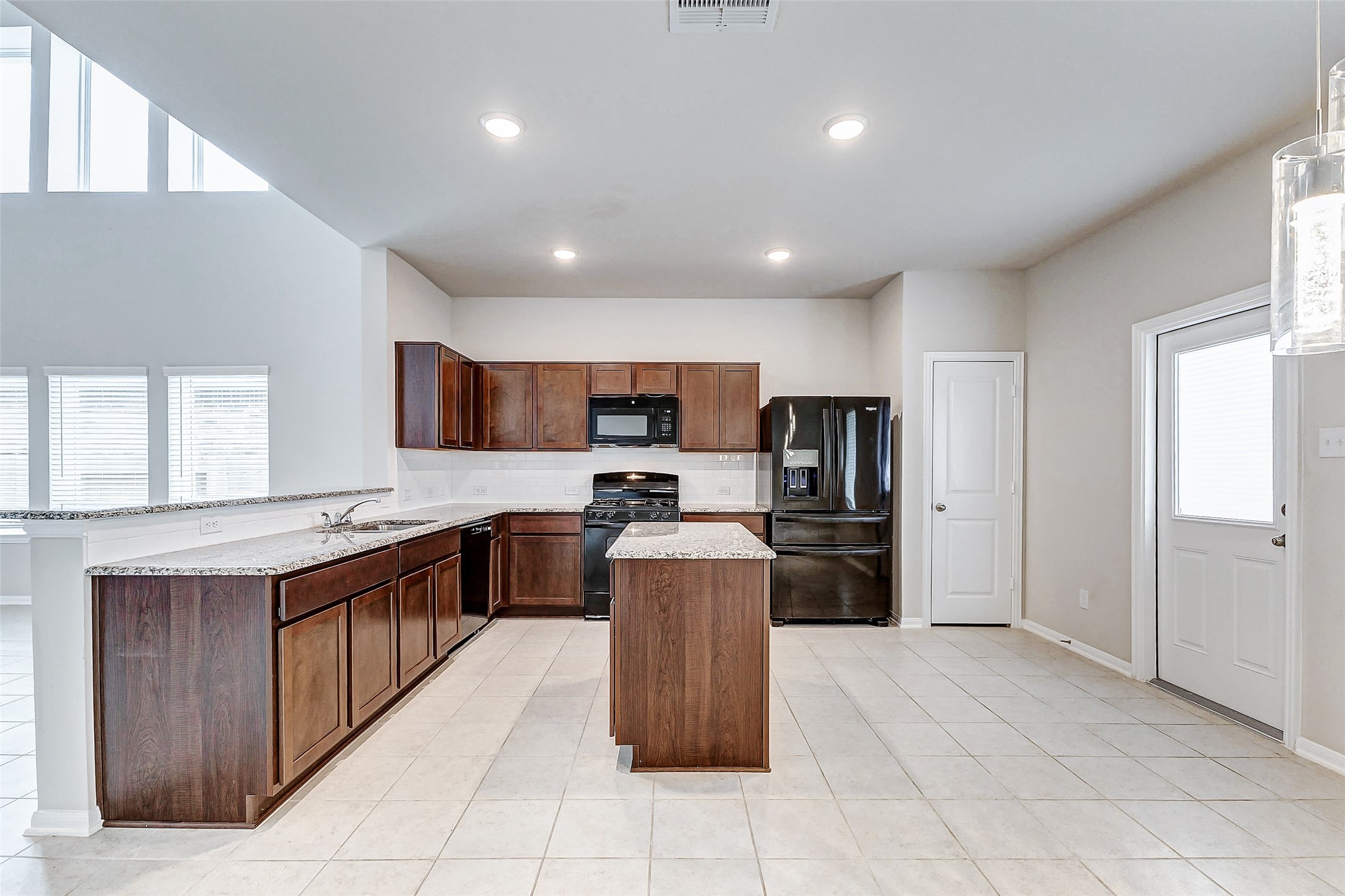 10511 Snowy Ridge Lane Rosharon, TX 77583 - Photo 10 of 32 a large kitchen with stainless steel appliances lots of counter space and a sink