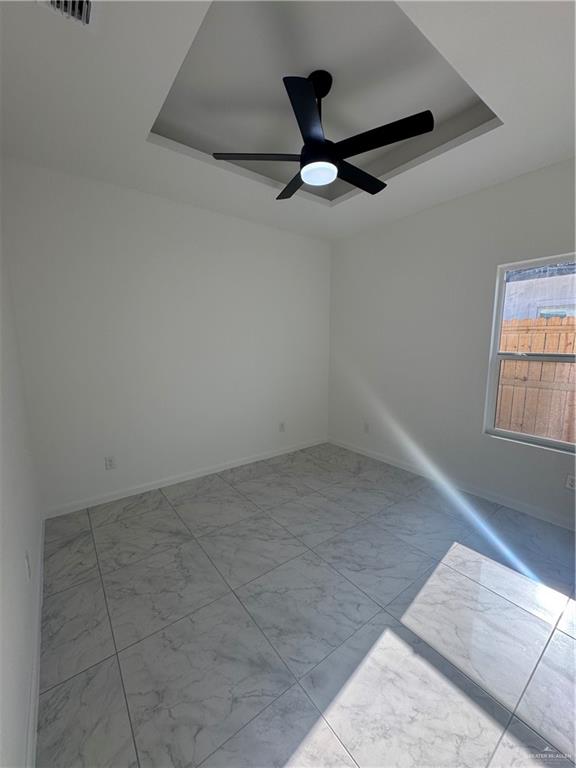 2109 Dragonfly St Mission, Unit 2 Mission, TX 78572 - Photo 11 of 16 an empty room with a ceiling fan and windows