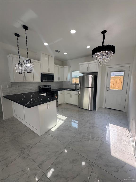2109 Dragonfly St Mission, Unit 2 Mission, TX 78572 - Photo 3 of 16 a kitchen with stainless steel appliances granite countertop a sink a stove and cabinets