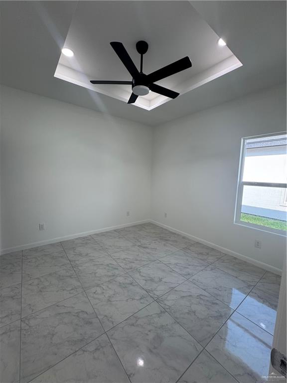 2109 Dragonfly St Mission, Unit 2 Mission, TX 78572 - Photo 5 of 16 an empty room with ceiling fan and window