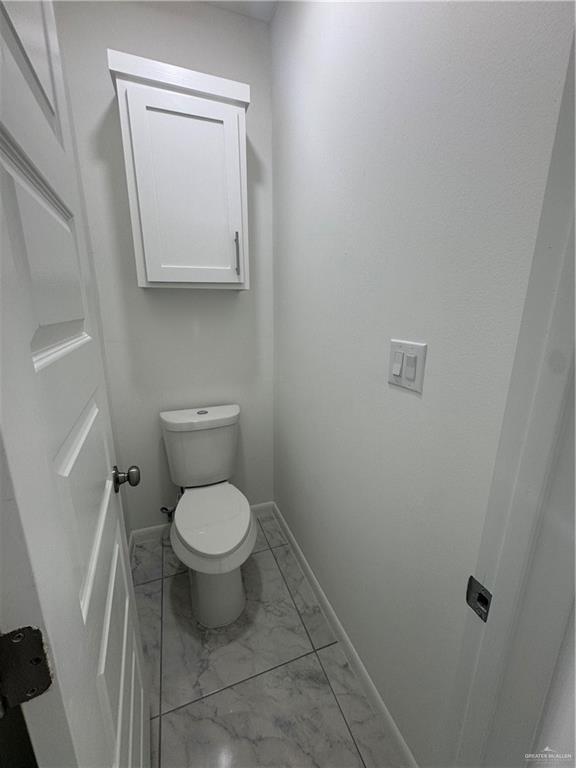 2109 Dragonfly St Mission, Unit 2 Mission, TX 78572 - Photo 8 of 16 a white toilet sitting next to a white sink