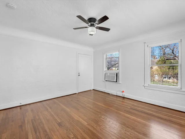 wooden floor in an empty room with a window