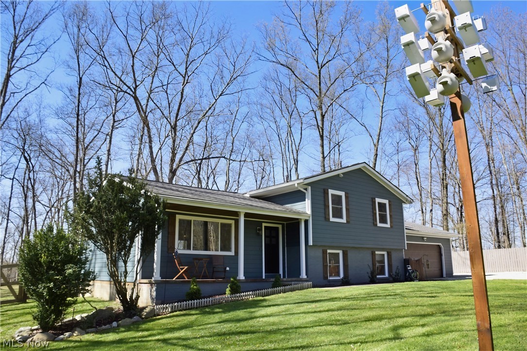6770 Akron Peninsula Road Peninsula, OH 44264 - Photo 3 of 35 Split level home featuring a garage and a front yard