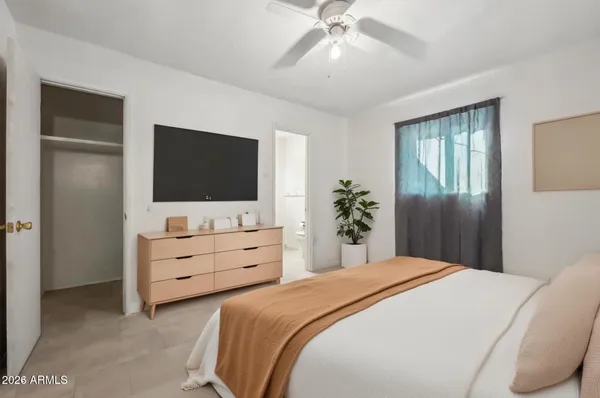 a bedroom with a bed and a flat screen tv in a dresser