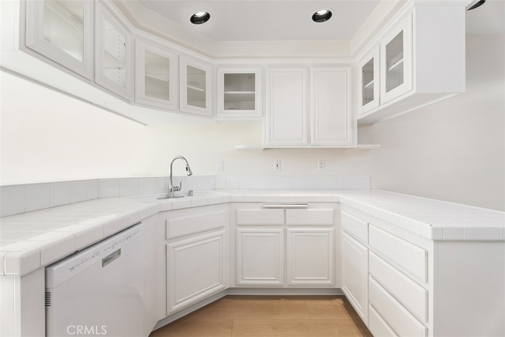 6 Stoney Pointe Laguna Niguel, CA 92677 - Photo 11 of 37 a kitchen with white cabinets and sink