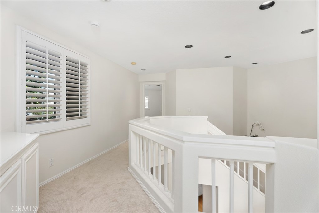 6 Stoney Pointe Laguna Niguel, CA 92677 - Photo 18 of 37 a bedroom with a bed and a window