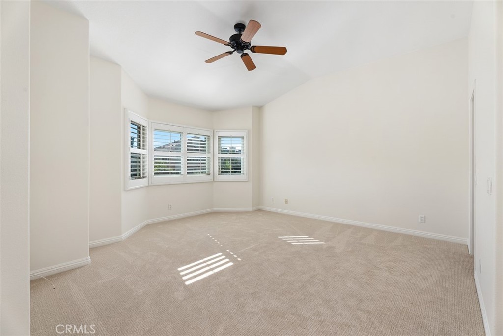 6 Stoney Pointe Laguna Niguel, CA 92677 - Photo 20 of 37 an empty room with windows and ceiling fan