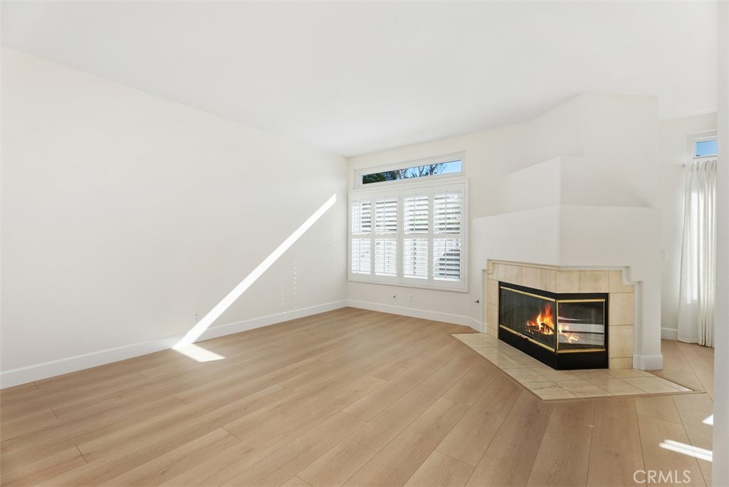 6 Stoney Pointe Laguna Niguel, CA 92677 - Photo 5 of 37 wooden floor in an empty room with a fireplace