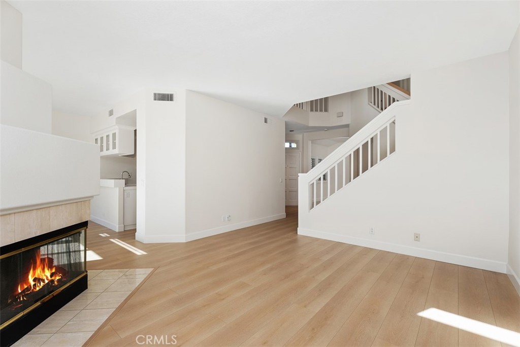 6 Stoney Pointe Laguna Niguel, CA 92677 - Photo 7 of 37 a view of an empty room with wooden floor and a fireplace
