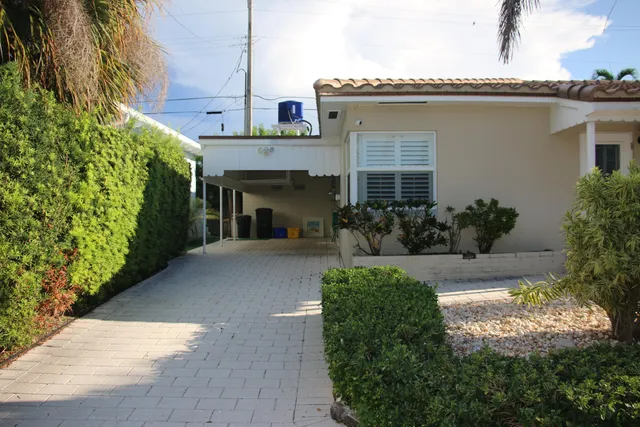 a view of a house with potted plants