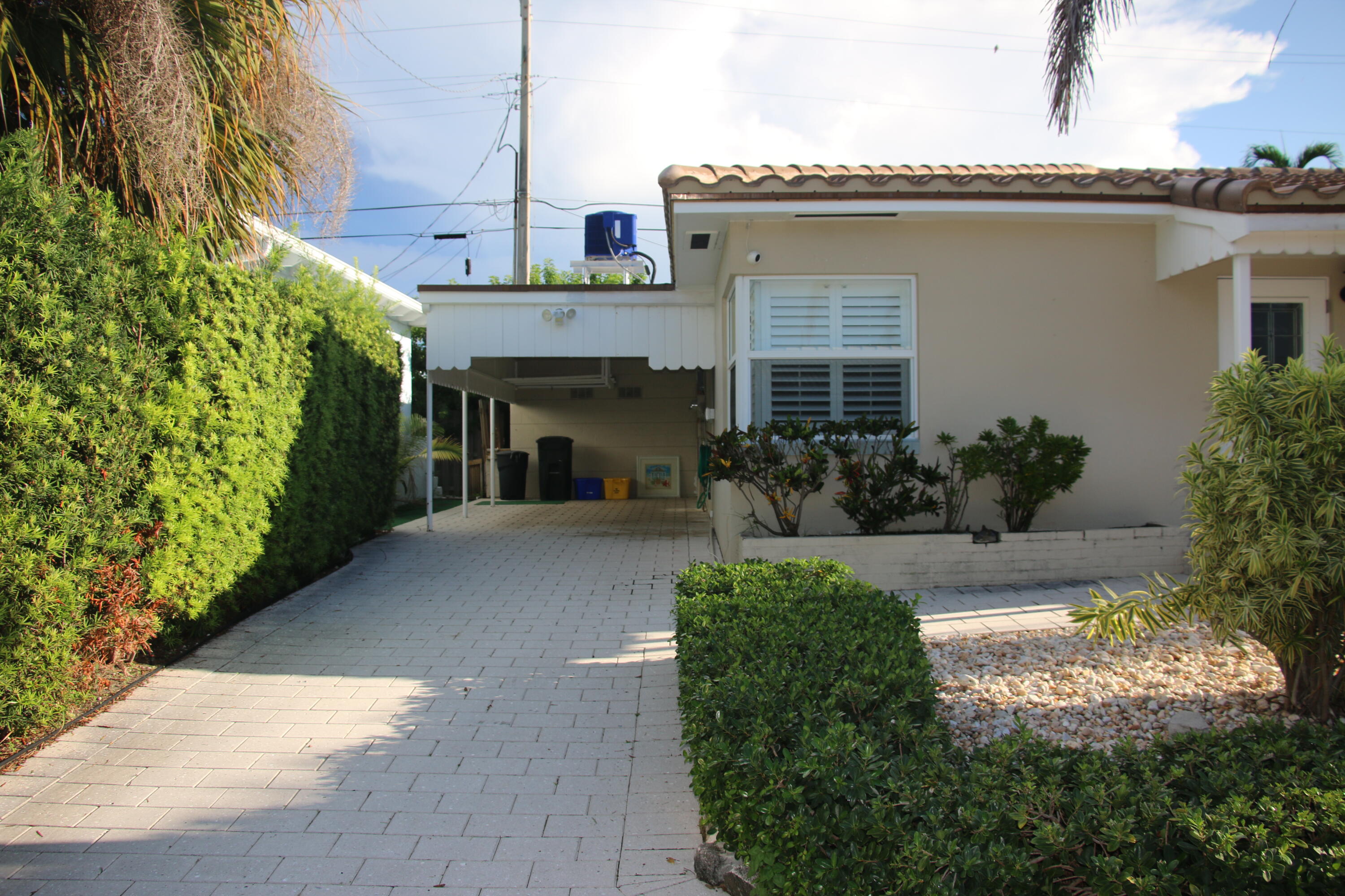 42 Douglas Drive Ocean Ridge, FL 33435 - Photo 2 of 8 a view of a house with potted plants