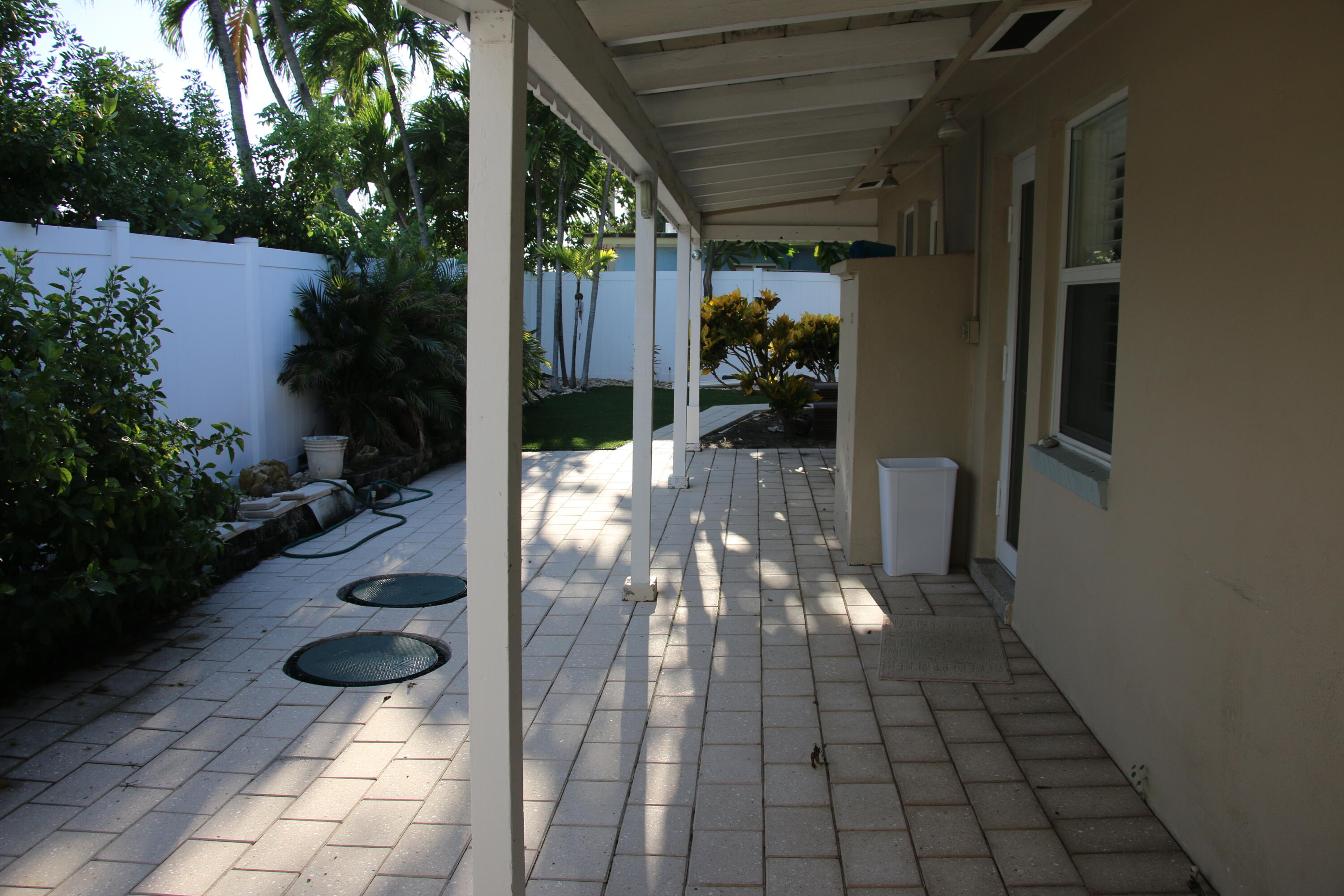 42 Douglas Drive Ocean Ridge, FL 33435 - Photo 3 of 8 a view of a porch with chairs and potted plants