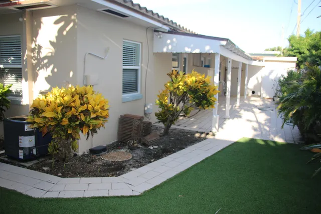 a view of a house with a yard and sitting area