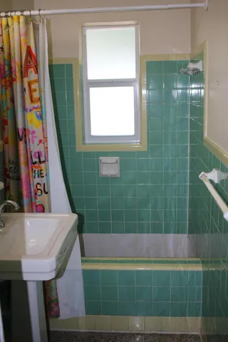 a view of a bathroom with a sink and a bath tub