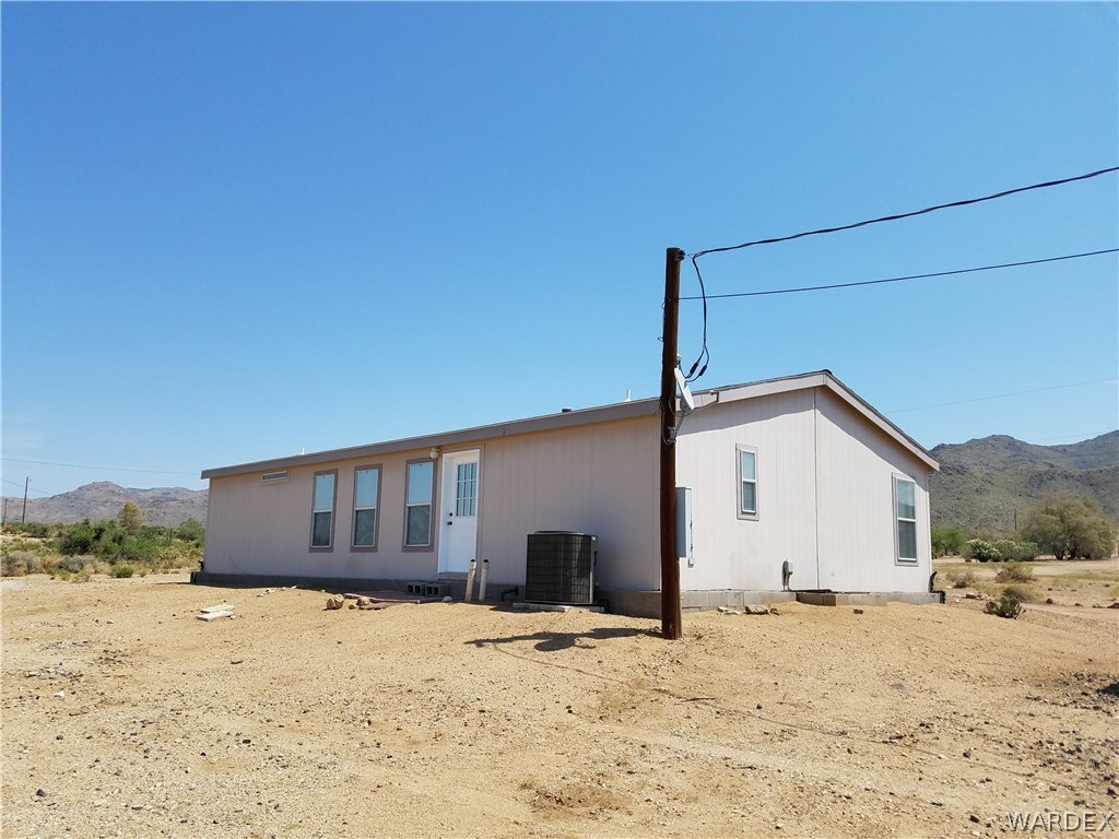 3955 Bosque Road Golden Valley, AZ 86413 - Photo 18 of 27 a view of a house with a yard