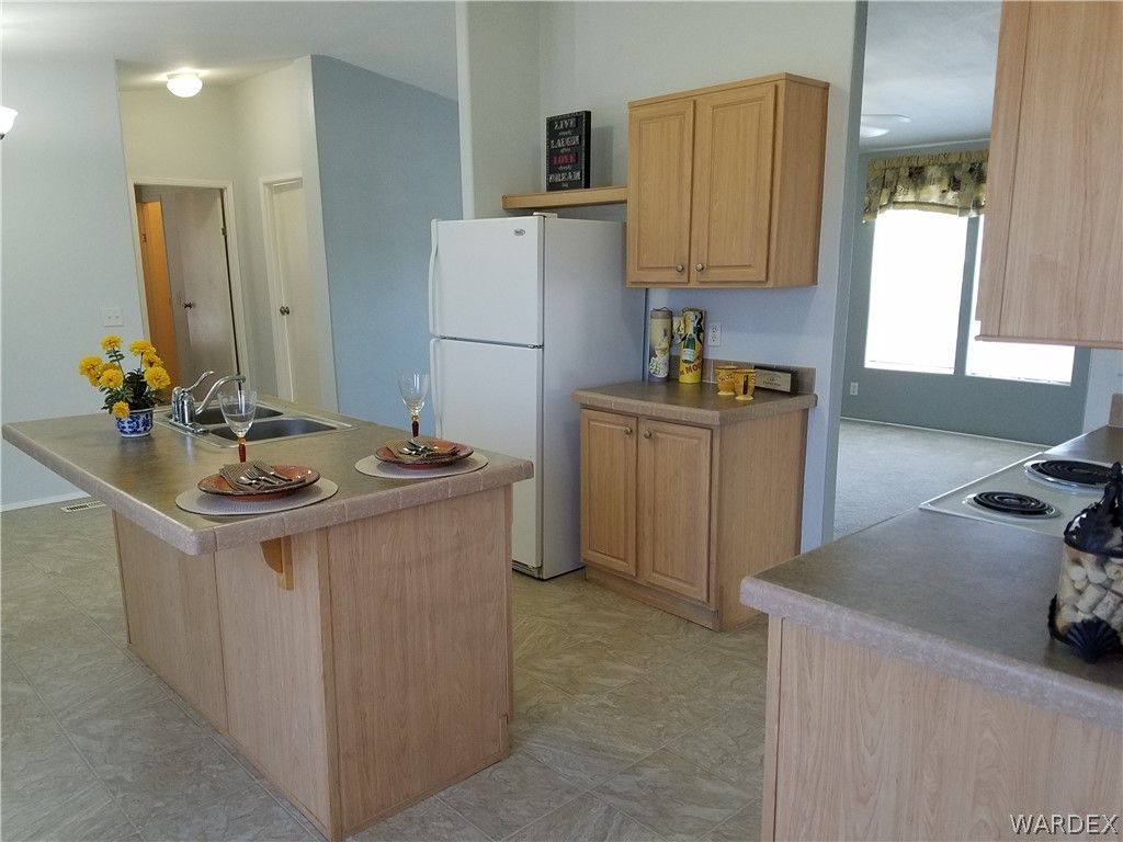 3955 Bosque Road Golden Valley, AZ 86413 - Photo 2 of 27 a kitchen with stainless steel appliances granite countertop a sink stove and refrigerator