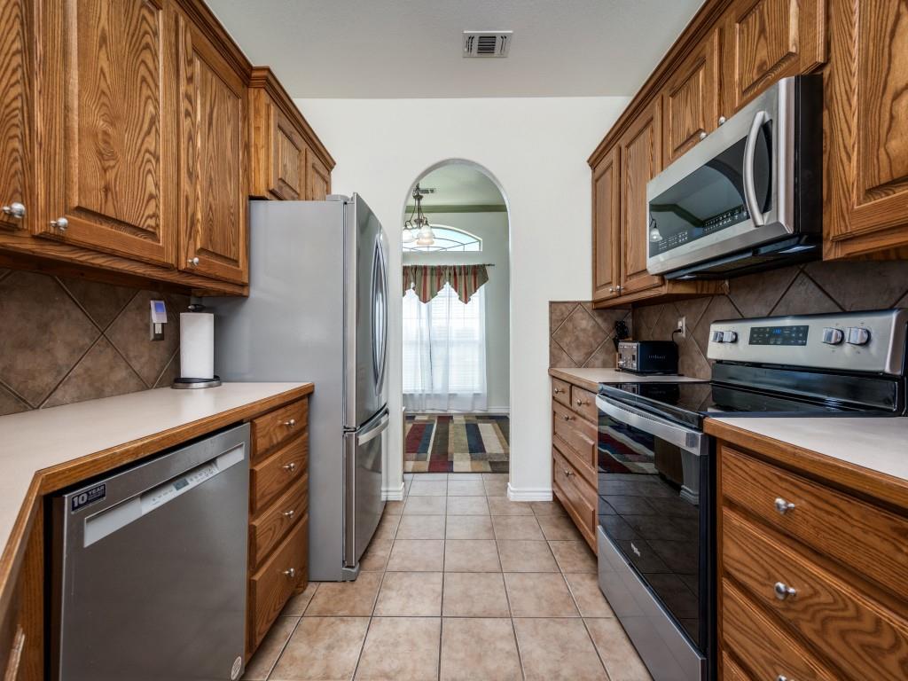 100 County Road 4181 Decatur, TX 76234 - Photo 12 of 35 a kitchen with stainless steel appliances granite countertop a stove and a microwave