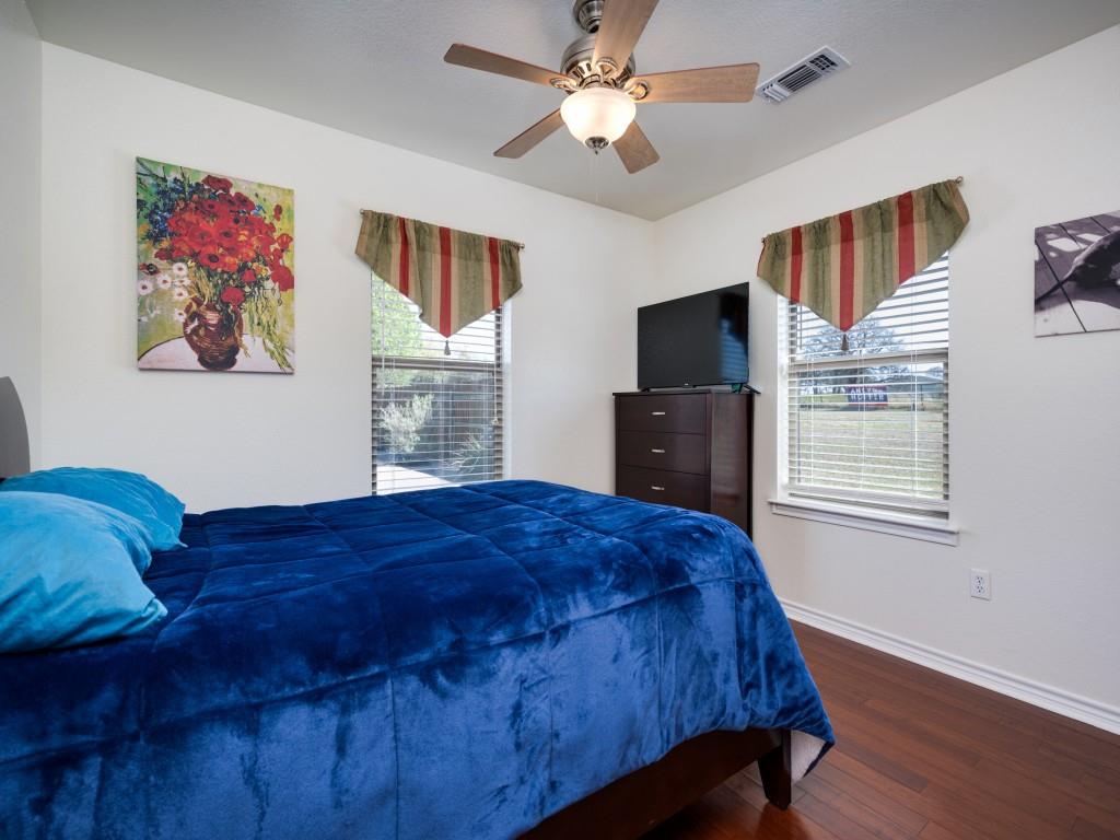 100 County Road 4181 Decatur, TX 76234 - Photo 21 of 35 a bedroom with a bed and a flat screen tv