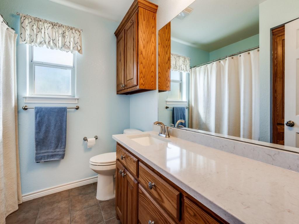 100 County Road 4181 Decatur, TX 76234 - Photo 22 of 35 a bathroom with a sink a toilet and shower