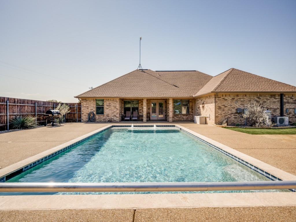 100 County Road 4181 Decatur, TX 76234 - Photo 28 of 35 a swimming pool view with a seating space and a garden view