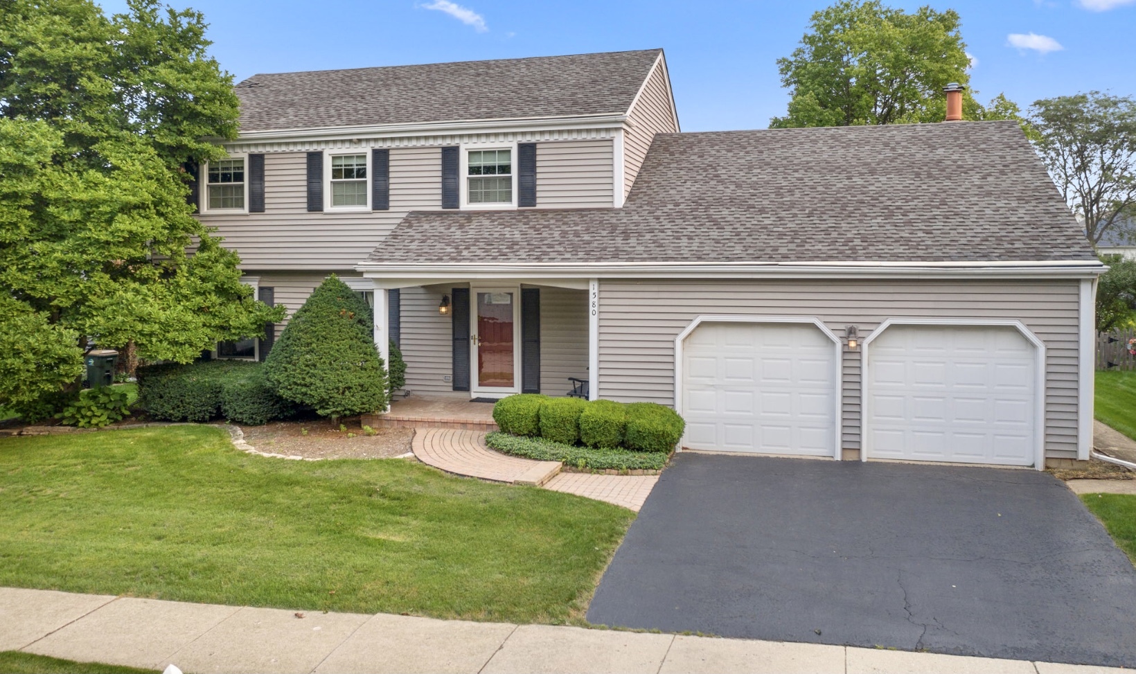 1580 Clemson Drive Naperville, IL 60565 - Photo 1 of 34 a front view of a house with garden