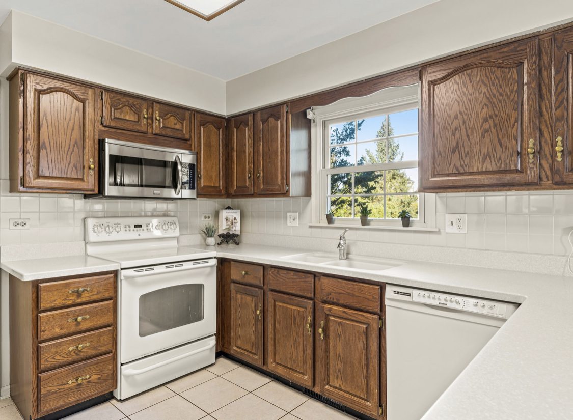 1580 Clemson Drive Naperville, IL 60565 - Photo 11 of 34 a kitchen with stainless steel appliances a refrigerator sink and cabinets